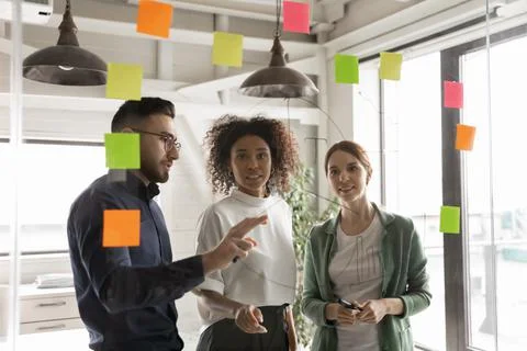 Multiracial colleagues develop ideas in office together Stock Photos