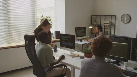 Multiracial Colleagues Discussing Program Coding in Office Stock Footage 255782520