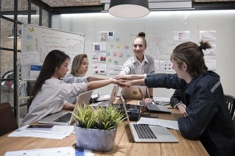 Multiracial colleagues teamwork joining hands together in a meeting room. Foto stock