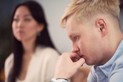 Multiracial couple having argument during psychotherapy session Stock Photos