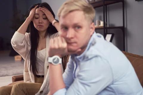 Multiracial couple having argument during psychotherapy session Stock Photos