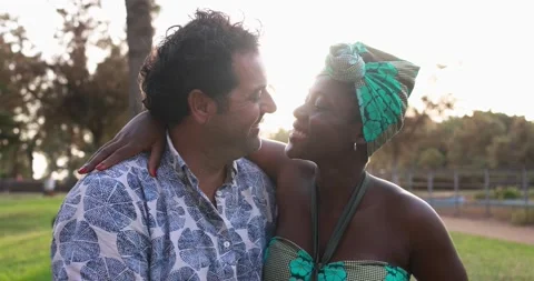 Multiracial couple having tender moment together at city park 库存影片 170004094