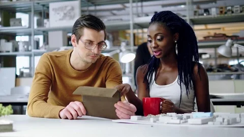 Multiracial couple working in design and engineering architecture office Stock Footage 85380727