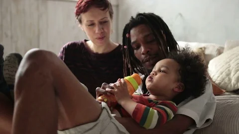 Multiracial curly boy drinking from feeding bottle Video stock 73781141
