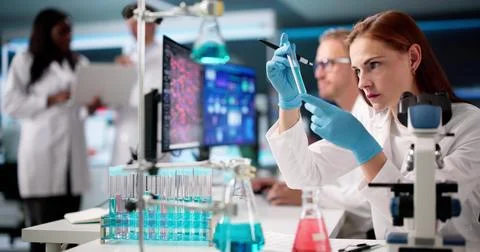 Multiracial Doctors In Laboratory Analyzing Data On Computer Screens Together 写真素材