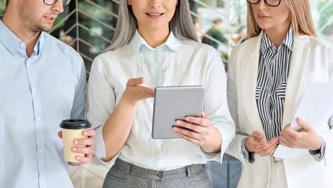 Multiracial employees colleagues working using tablet device in office. Stock Photos
