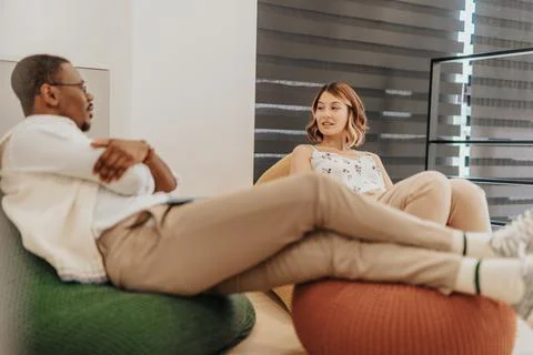 Multiracial employees taking a break from work. Diverse coworkers lying on lazy Stock Photos