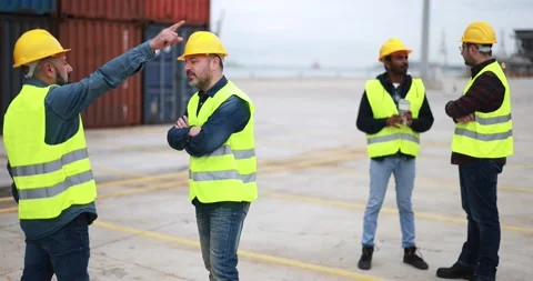 Multiracial engineer men controlling shipping containers inside industrial port Stock Footage 179970609