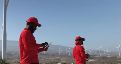 Multiracial engineer men working together on a windmill farm Stock Footage 194266309