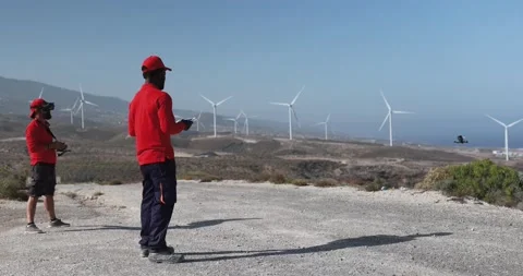 Multiracial engineer men working together on a windmill farm Stock Footage 194266366
