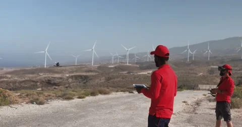 Multiracial engineer men working together on a windmill farm Stock Footage 194266385
