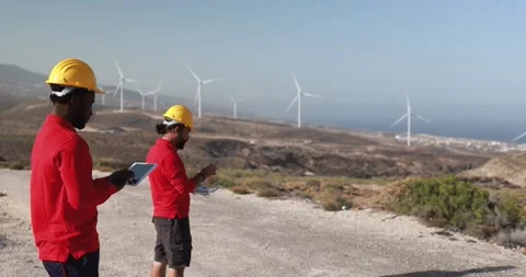 Multiracial engineer men working together on a windmill farm Stock Footage 194266503