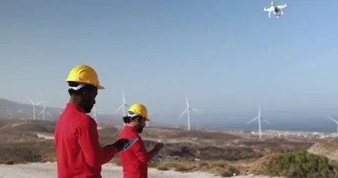 Multiracial engineer men working together on a windmill farm Stock Footage 194266535