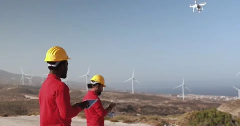 Multiracial engineer men working together on a windmill farm Stock Footage 194266546