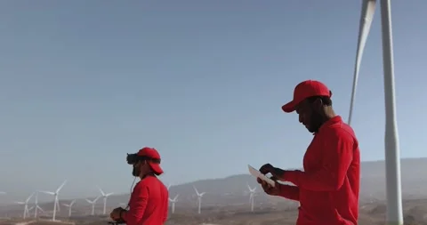 Multiracial engineer men working together on a windmill farm Stock Footage 194266571