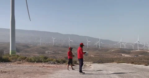 Multiracial engineer men working together on a windmill farm Stock Footage 194266672