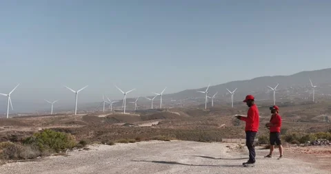 Multiracial engineer men working together on a windmill farm Stock Footage 194266723