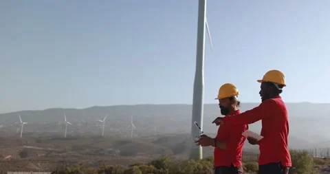 Multiracial engineer men working together on a windmill farm Stock Footage 194266809