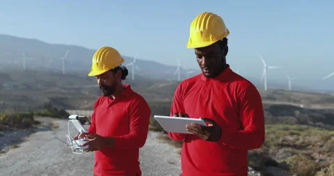 Multiracial engineer men working together on a windmill farm Stock Footage 194266846