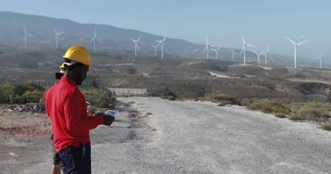 Multiracial engineer men working together on a windmill farm Stock Footage 194266887