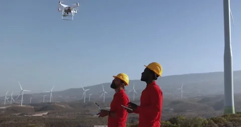 Multiracial engineer men working together on a windmill farm Stock Footage 194266943