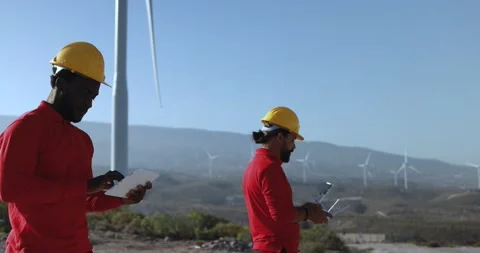 Multiracial engineer men working together on a windmill farm Stock Footage 194266972