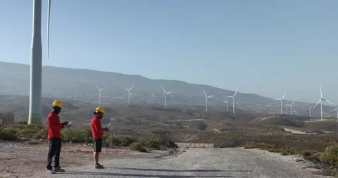 Multiracial engineer men working together on a windmill farm Stock Footage 194267037