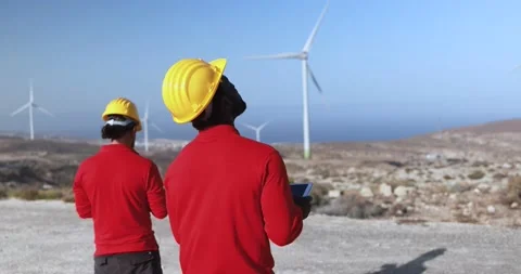 Multiracial engineer men working together on a windmill farm Stock Footage 194267065