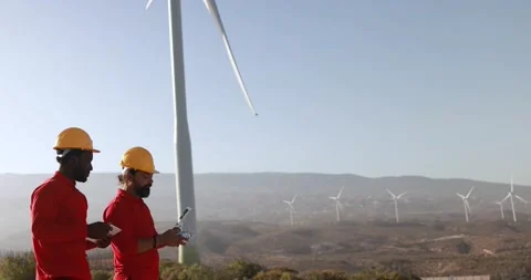 Multiracial engineer men working together on a windmill farm Stock Footage 194267102