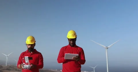 Multiracial engineer men working together on a windmill farm Stock Footage 194267199