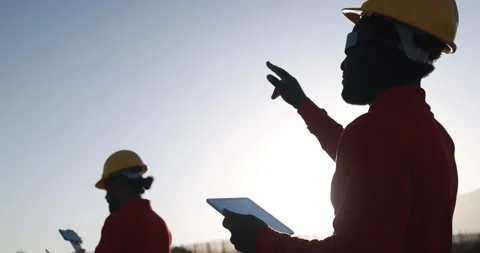 Multiracial engineer men working together on a windmill farm Stock Footage 194267210