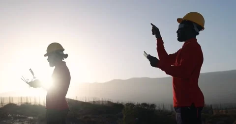 Multiracial engineer men working together on a windmill farm Stock Footage 194267238