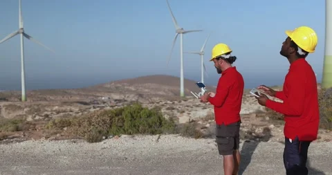 Multiracial engineer men working together on a windmill farm Stock Footage 194267387
