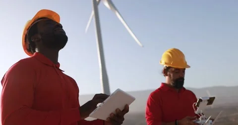 Multiracial engineer men working together on a windmill farm Stock Footage 194267498