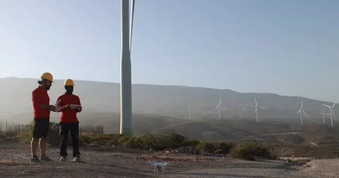 Multiracial engineer men working together on a windmill farm Stock Footage 194267609