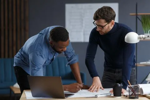 Multiracial engineer team working in office with blue prints and architect Foto stock