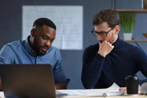 Multiracial engineer team working in office with blue prints and architect Stock Photos