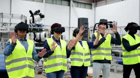Multiracial engineers using virtual reality headsets at robotic factory Stock Footage 230245173