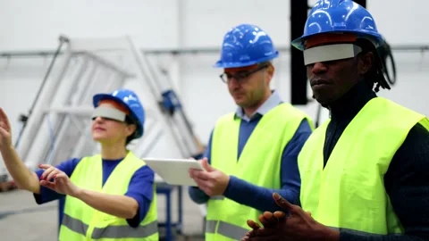 Multiracial engineers working with augmented reality glasses at robotic factory  Stock Footage 229640254