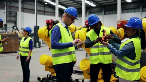 Multiracial engineers working at robotic automation facility - Industrial robot  Stock Footage 229640198