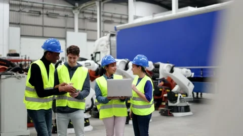 Multiracial engineers working at robotic automation facility - Industrial robot  Stock Footage 230244928