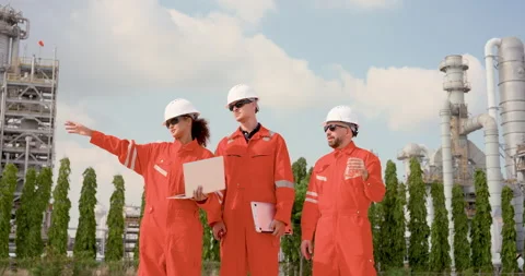 Multiracial female supervisor gestures during refinery field briefing with two Stock Footage 337392421