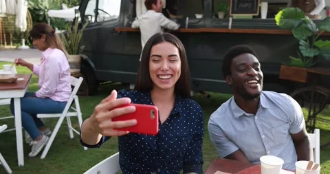 Multiracial friends eating and using mobile phone for a video call Stock Footage 156453510