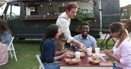 Multiracial Friends Eating At Food Truck Table Outdoor - Summer And Lifestyle Stock Footage