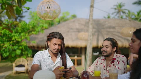 Multiracial friends gather, refreshing drinks on table. Casual attire Stock Footage 264865524