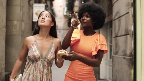 Multiracial friends using the mobile outdoors and they drop them Stock Footage 255552166