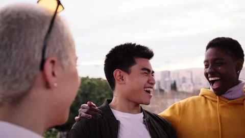 Multiracial group of diverse guys sitting outdoors having fun. Young multi Stock Footage 249704160