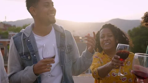 Multiracial group of friends dancing and toasting with red wine celebrating Stock Footage 244174858