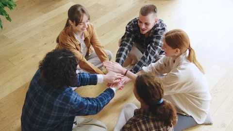 Multiracial Group of friends engaged in a team-building activity indoors during Stock Footage 307962244