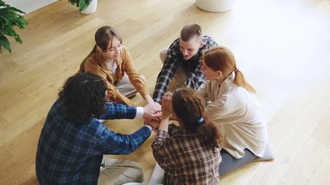 Multiracial Group of friends engaged in a teamwork activity indoors, fostering Stock Footage 307962115